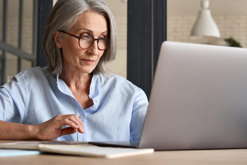Woman looking for administrative death procedures on her computer