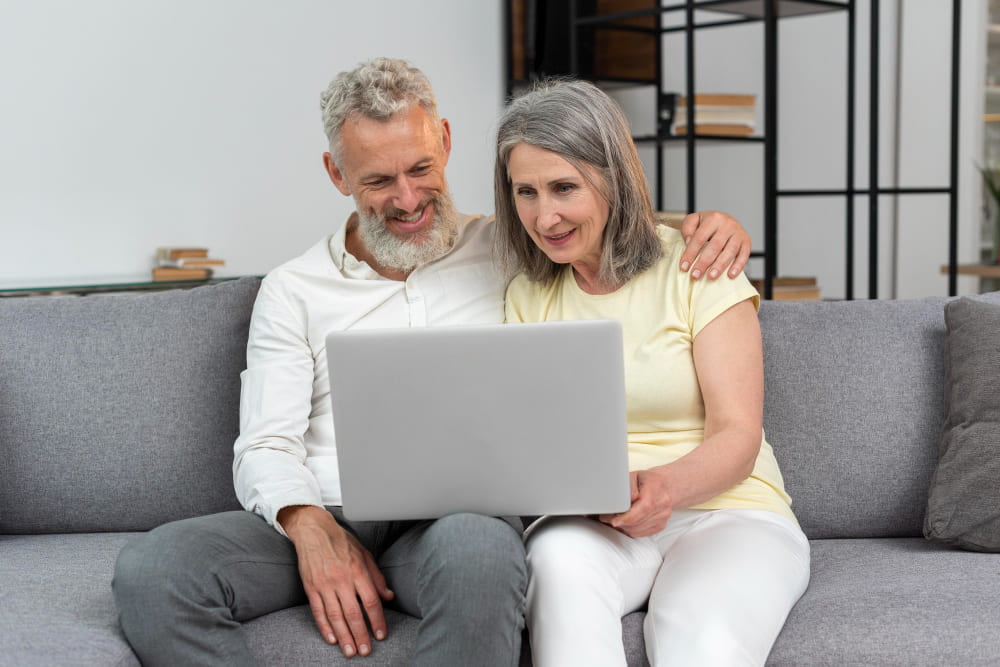 couple looking at a computer list of organizations to notify in the event of death